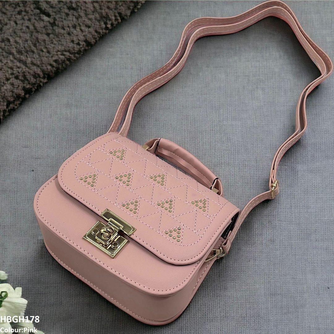 “Pink crossbody handbag with gold studded triangle pattern and adjustable strap — stylish women’s fashion bag.”